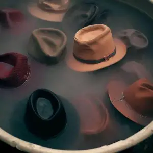 soaking hats in laundry stripping solution in bucket