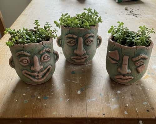 7. Clay Face Plant Pots (Messy but Cute)