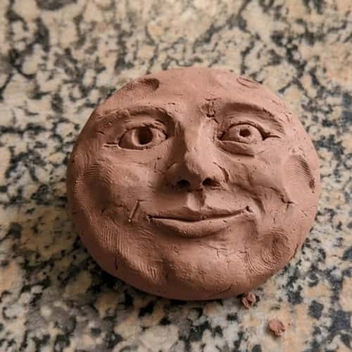 12. Clay Moon Face Sculpture