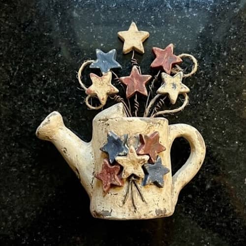 7. Primitive Americana Watering Can With Flag Blooms