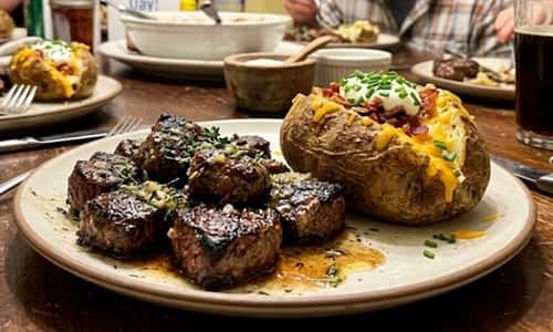 8. Garlic Butter Steak Bites with Loaded Baked Potatoes