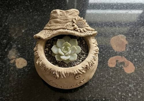 10. Autumn Storybook Scarecrow Planter