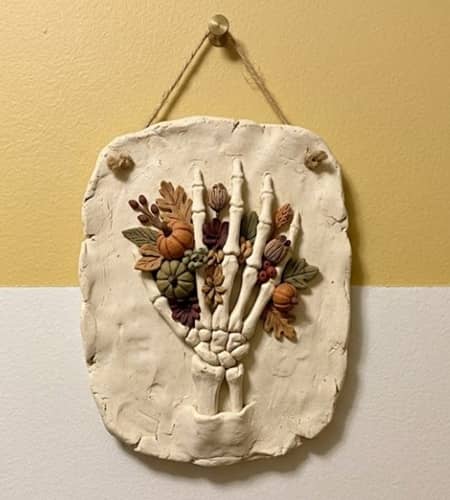 6. Skeleton Hand Holding Wildflowers