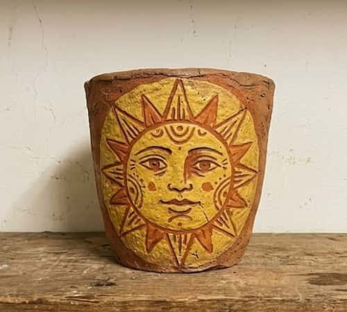 1. Sculpted Sun Face Patio Clay Pot
