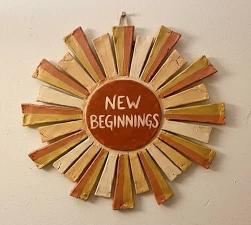 10. Clay Sunburst “New Beginnings” Plaque