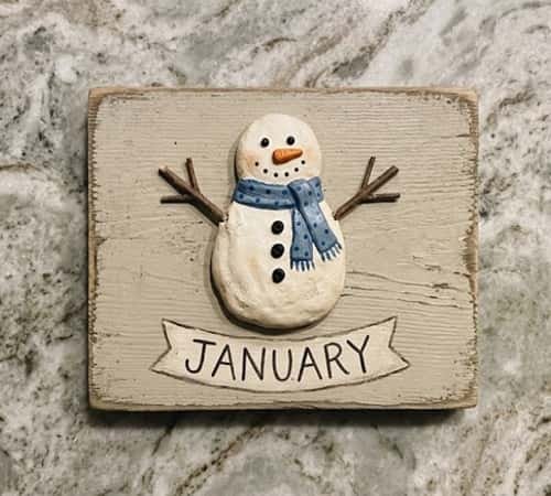 11. Rustic Clay Wooden Snowman Sign