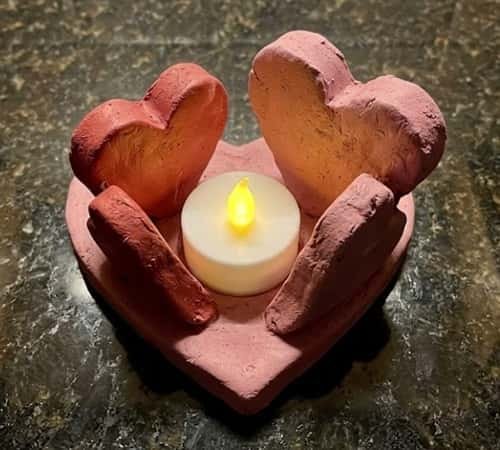 4. Two Hearts Hugging a Candle