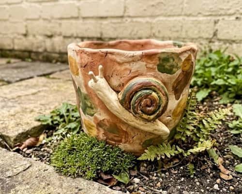 7. Whimsical Clay Snail Pot