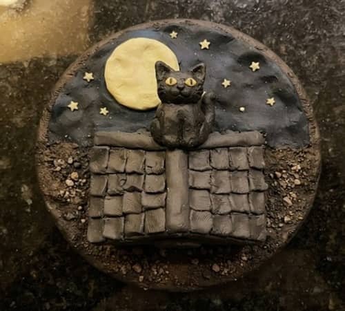 8. Black Cat Sitting on a Moonlit Roof