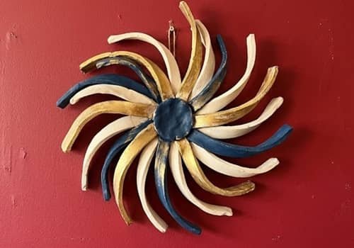 9. Clay Ribbon Burst Wall Sculpture