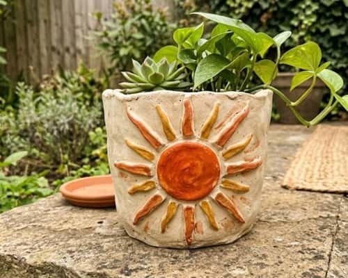 5. Sunburst Boho Clay Flower Pot
